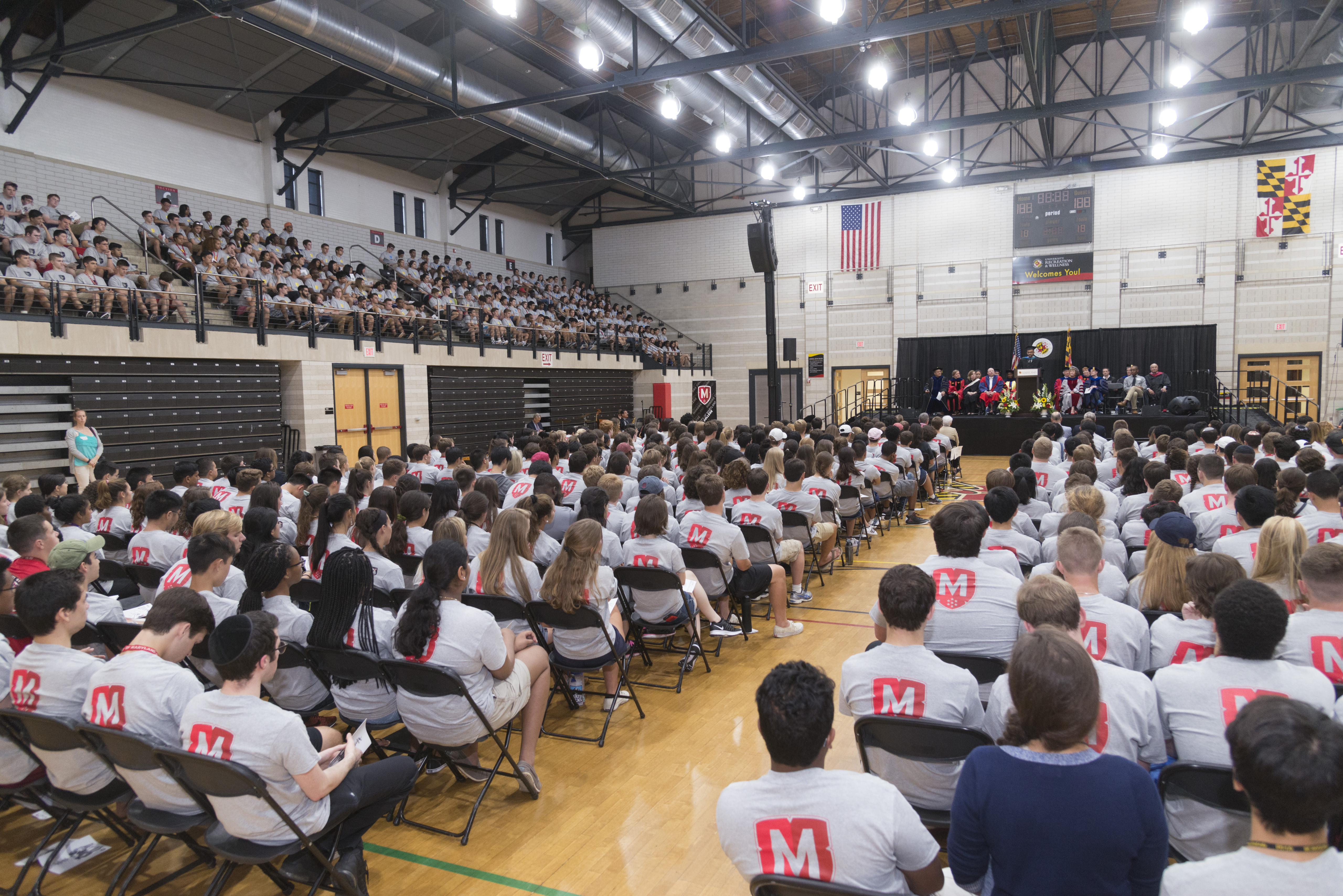 past ceremony with students and stage in distance