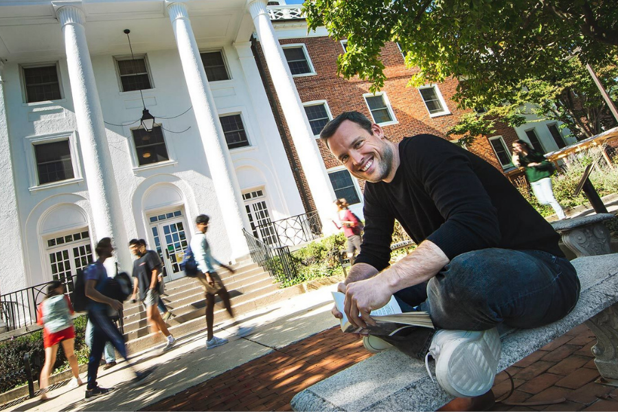 prof bauer sits outside arundel hall