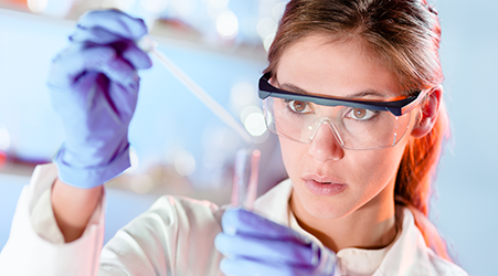 Student in science lab with beaker